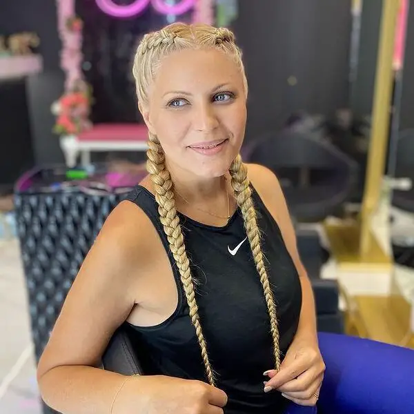 Trenzas dobles holandesas: una mujer con una camiseta sin mangas Nike negra