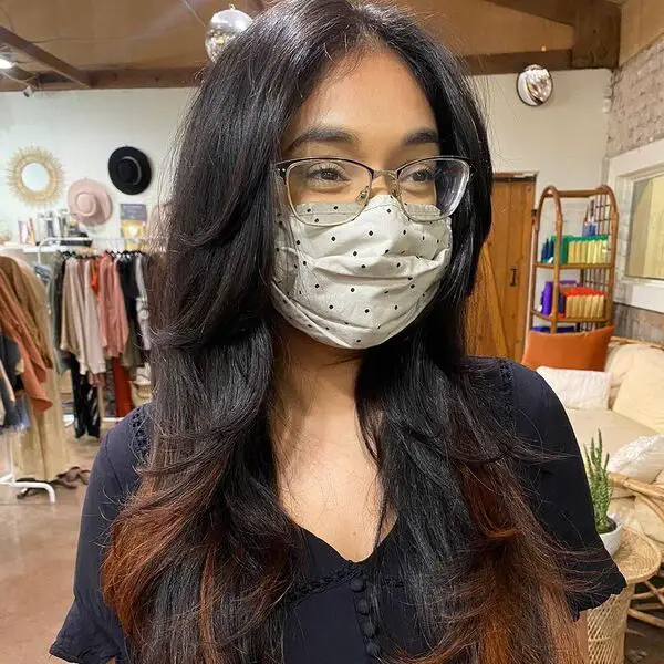Encuadre facial y flequillo de cortina: una mujer con anteojos y una máscara facial