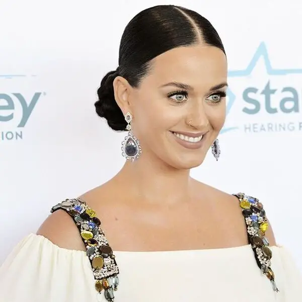Cabello de Katy Perry - Peinado de moño elegante con parte media - una mujer que lleva una blusa blanca con hombros descubiertos